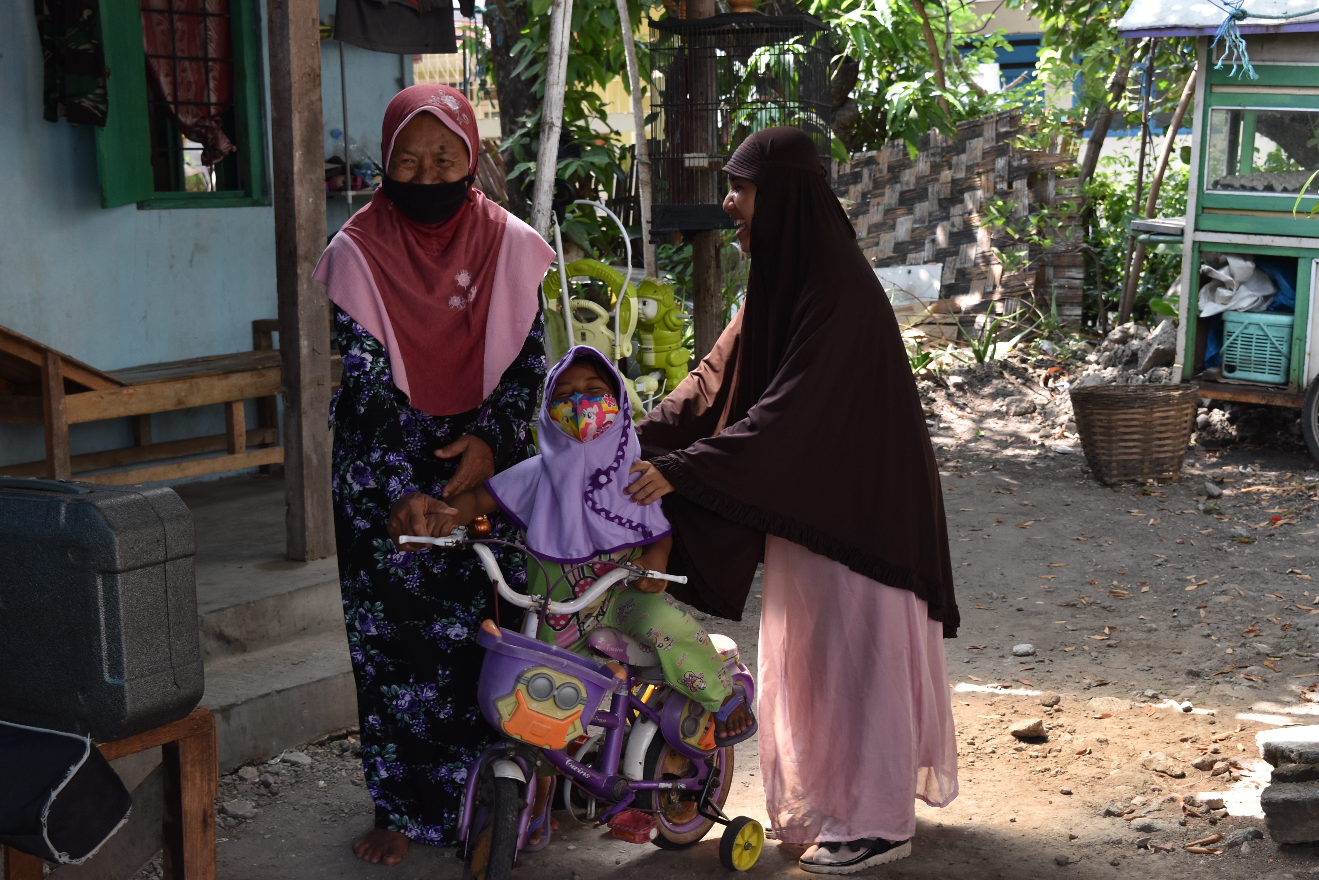 Susiana, her mother and daughter in a low-income neighbourhood in Indonesia. Cover Image