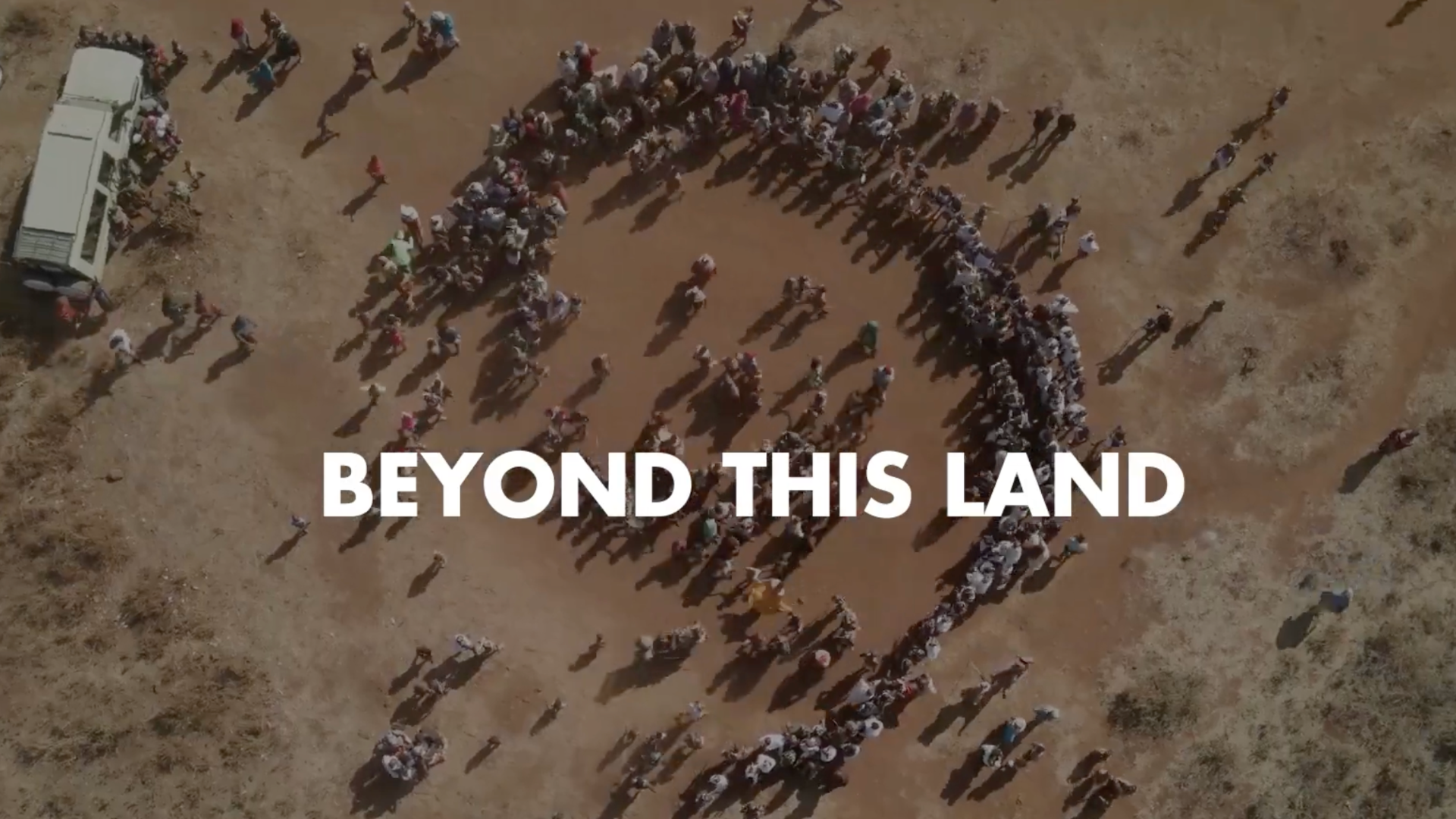 text reads, 'beyond this land' and shows a desert Cover Image