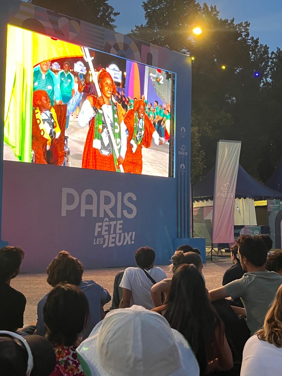 Opening ceremony being show on a large screen in fanpark