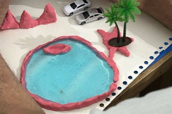 A story showcasing a lake made with blue slime and pink desert dunes and planes made from pink play-doh and toy cars and trees depicting the location as an oasis in the desert