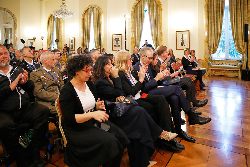 Audience clapping during panel and addresses in grand ball-room