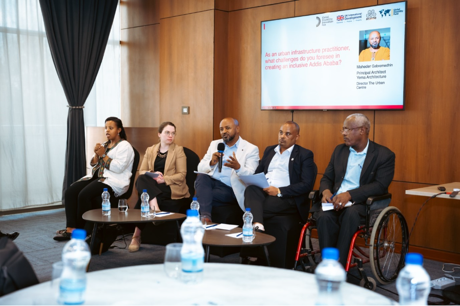 From left to right, panellist visible include: sign language interpreter; Mikaela Patrick, Head of Research & Delivery, GDI Hub; Maheder Gabremedhin, Director, The Urban Centre (speaking); Sisay Tilahun, CEO, Disability Affairs, Ministry of Women and Social Affairs; and Yosef Fekadu, Executive Director, Inclusive Ethiopia. On screen a question reads: &lsquo;as an urban infrastructure practitioner, what challenges do you foresee in creating and inclusive Addis Ababa&rsquo;.