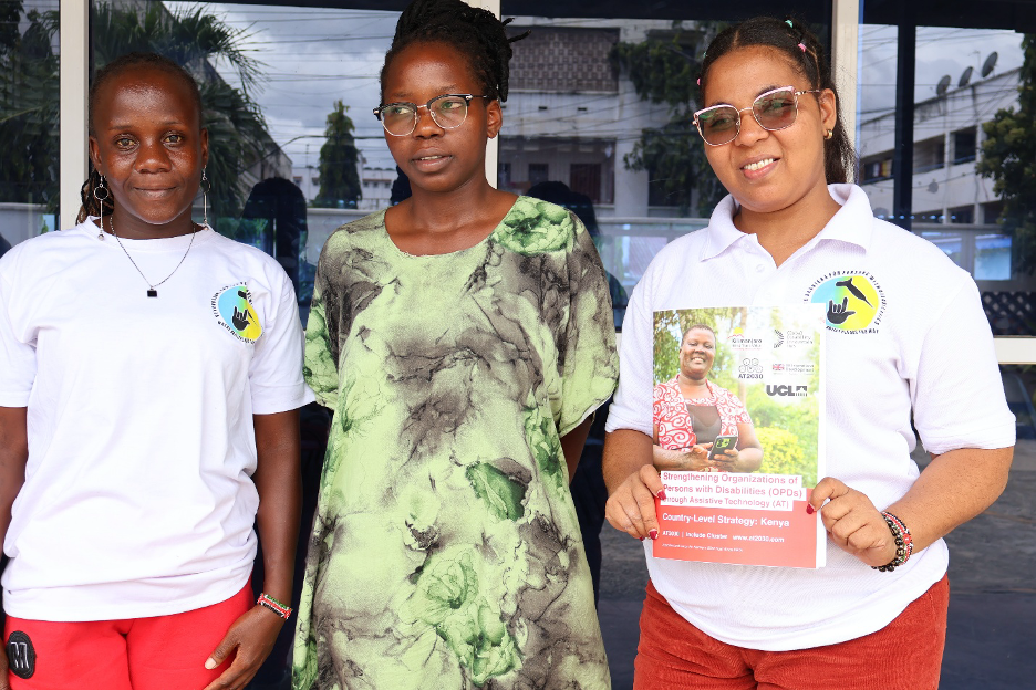 Stella Wangila holds the country-level strategy document, pictured alongside her colleagues from the group
