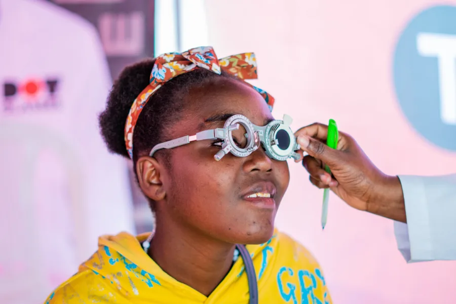 A lady getting her glassess fitted. 