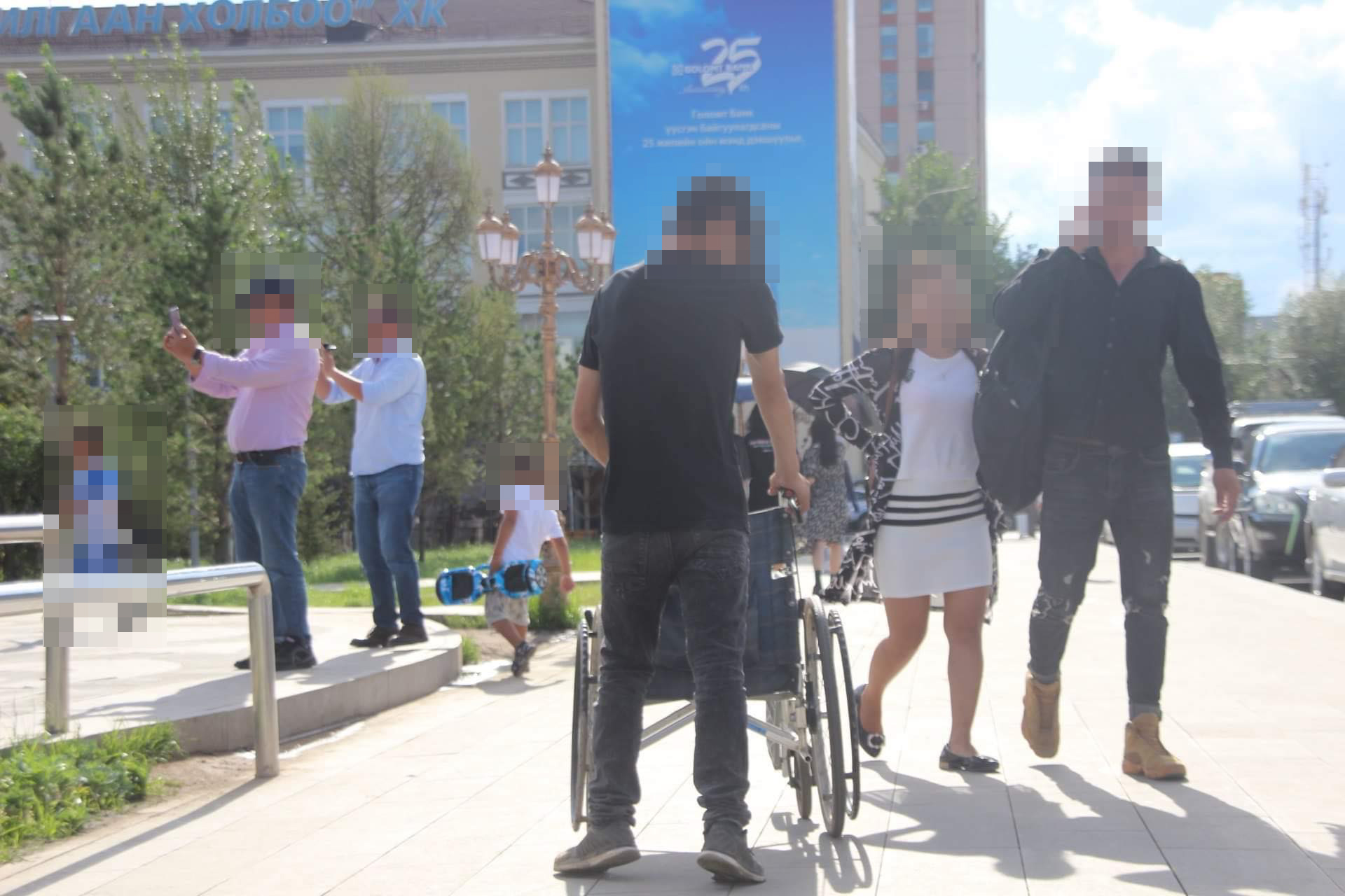 Street view: wheelchair user and other people walking