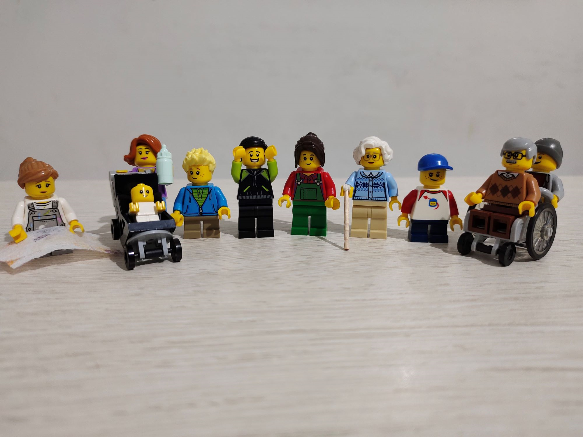 Lego figures in a line, including charactors using and wearing AT 