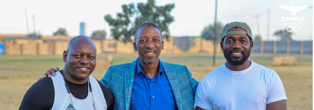 the image shows Richard Lubanza, NOC/CGA Zambia Secretary-General Boniface Kambikambi, and Coach Amon Moyo. (Photo courtesy of Zambia Olympic Committee) 