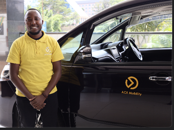 David Kamau standing next to his accessible vehicle