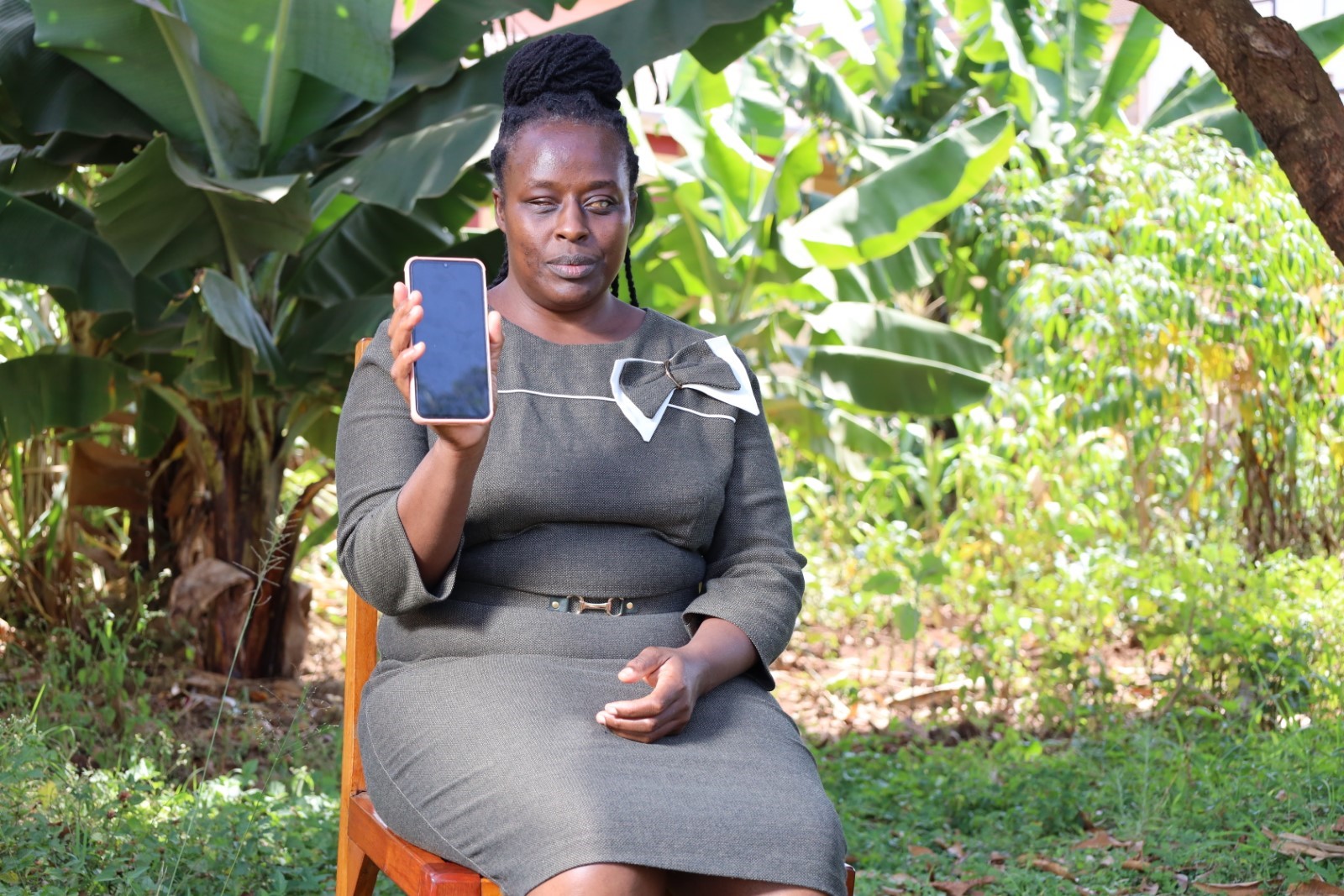 Felista holding the phone she was given at the begining of training