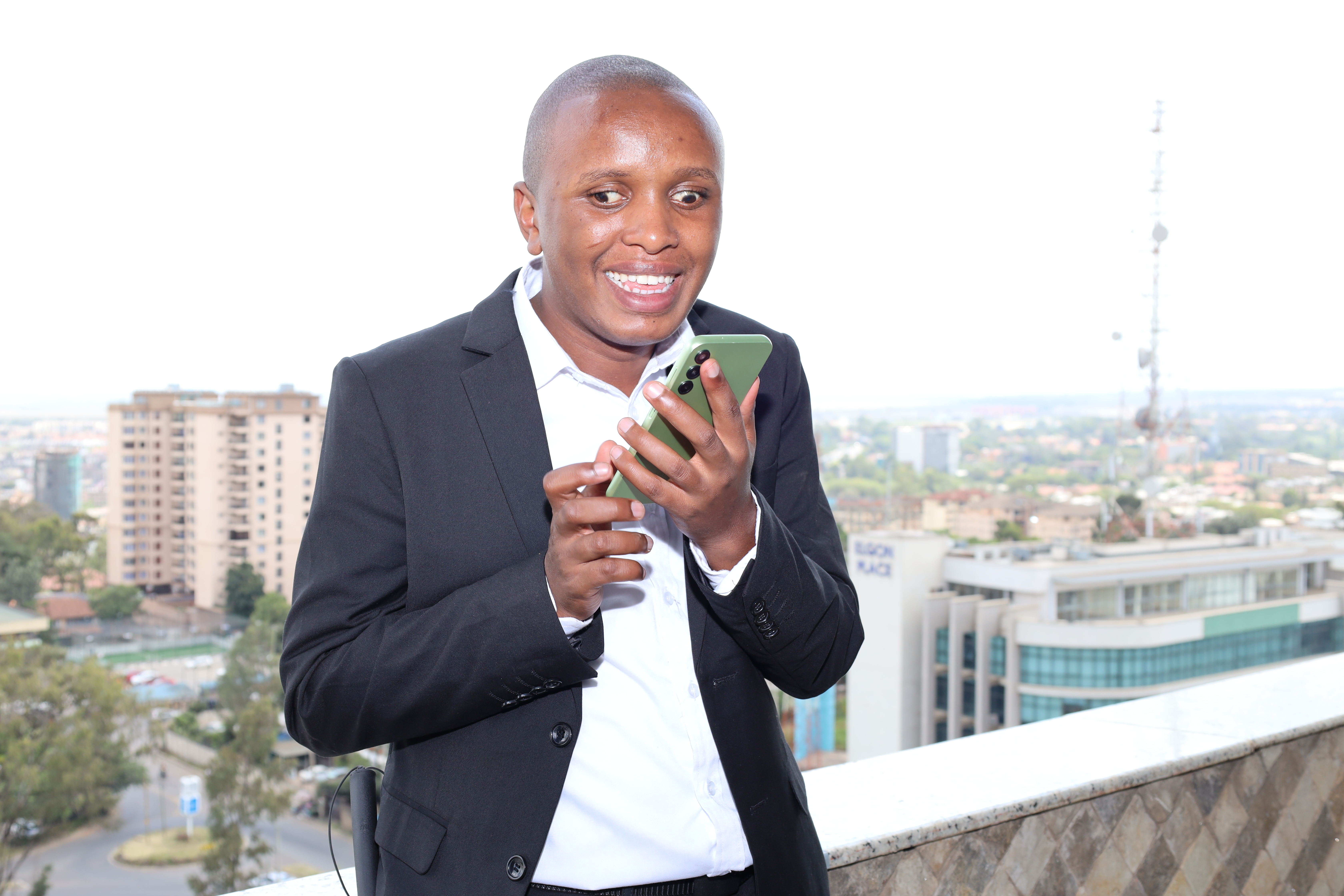 John Mwangi using a mobile phone