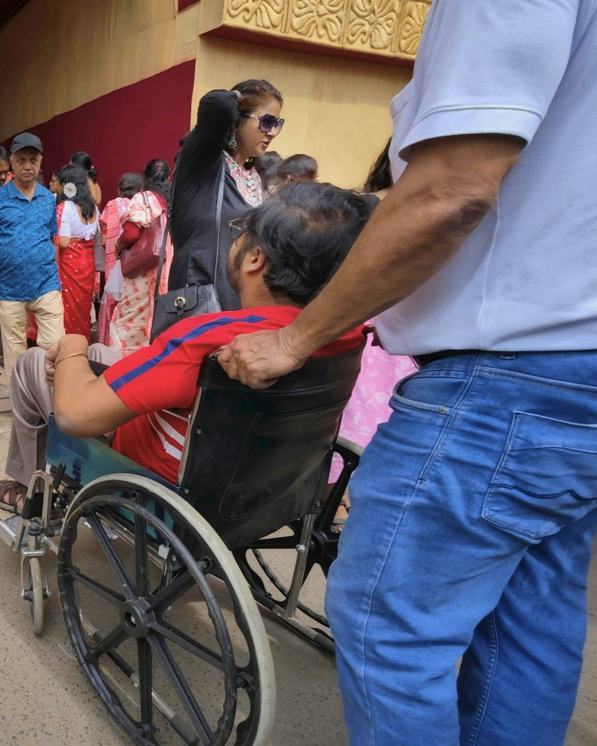 Person in wheelchair is moving with support from another person Cover Image