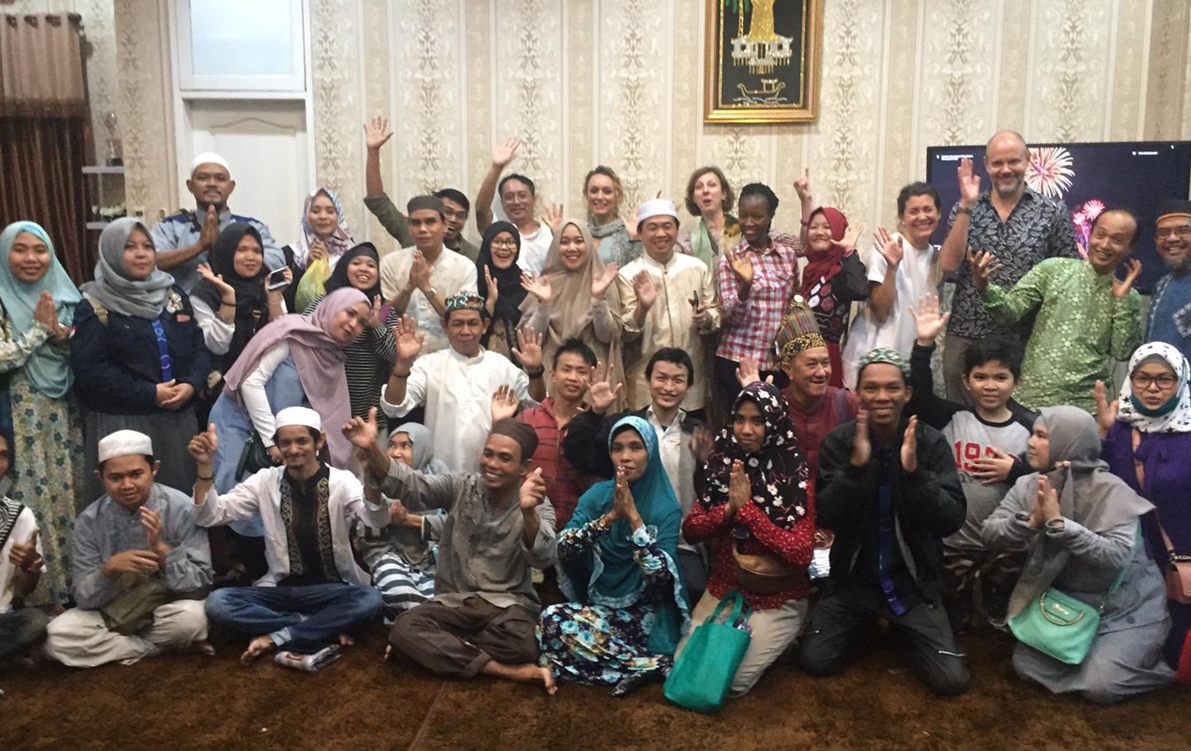 Large group of people smiling and raising their hands at an event for people with disabilities organised by the Mayor of Banjarmasin Cover Image